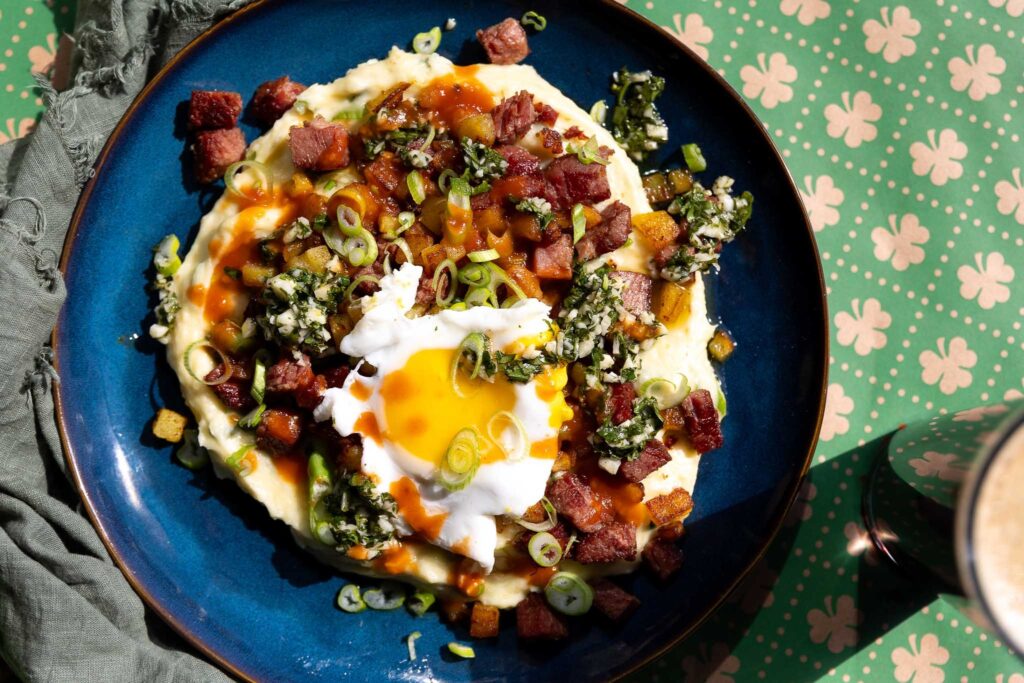 Corned beef hash on plate with beer in glass